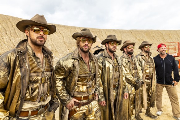 This image released by Universal Pictures shows actors, from left, Ryan Gosling and Aaron Taylor-Johnson, with stunt actors Ben Jenkin, Logan Holladay, and Justin Eaton, posing with director David Lei ...