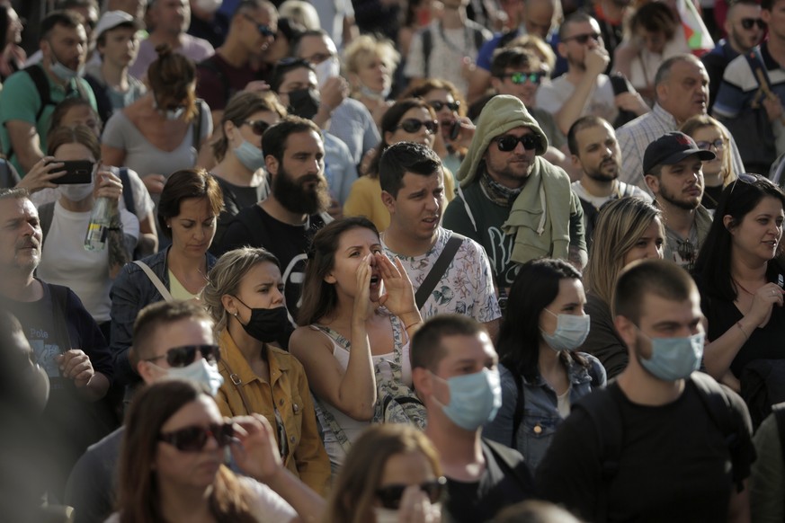 Protesters shout slogans as they take part in anti-governmental protest in downtown Sofia on Monday, July 13, 2020. Thousands of mostly young Bulgarians took to the streets on Monday to protest for th ...