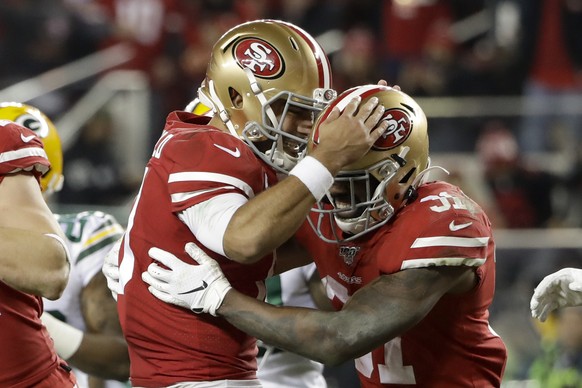 San Francisco 49ers running back Raheem Mostert, right, celebrates his touchdown with quarterback Jimmy Garoppolo during the second half of the NFL NFC Championship football game against the Green Bay ...