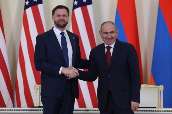 epa12720446 Vice President of the United States JD Vance (L) and Armenian Prime Minister Nikol Pashinyan (R) shake hands during a joint press statement after their meeting in Yerevan, Armenia, 09 Febr ...