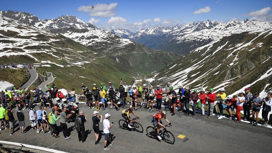 RE-EDIT - Egan Bernal from Colombia of Team Ineos, left, and Rohan Dennis from Australia of Bahrain-Merida Pro Cycling Team climb the Furka pass during the ninth and final stage, a 101.5 km race with  ...