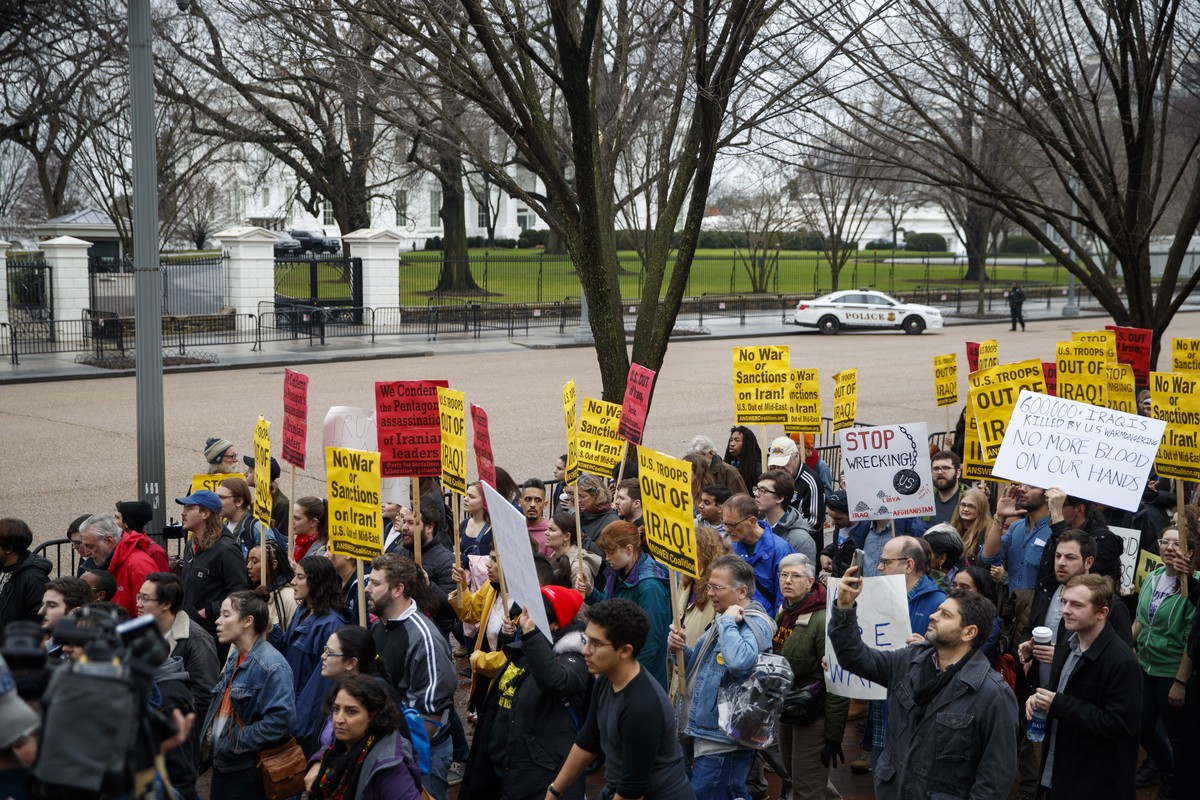 epa08102770 Demonstrators march from the White House to the Trump International Hotel to protest US military involvement in the Middle East in Washington, DC, USA, 04 January 2020. The Pentagon deploy ...