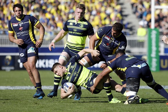 Leinster&#039;s Garry Ringrose, center, is tackled by Clermont&#039; players during their European Rugby Champions Cup semifinal match at Gerland stadium, in Lyon, central France, Sunday, April 23, 20 ...
