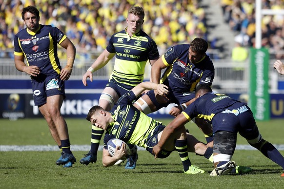 Leinster's Garry Ringrose, center, is tackled by Clermont' players during their European Rugby Champions Cup semifinal match at Gerland stadium, in Lyon, central France, Sunday, April 23, 20 ...