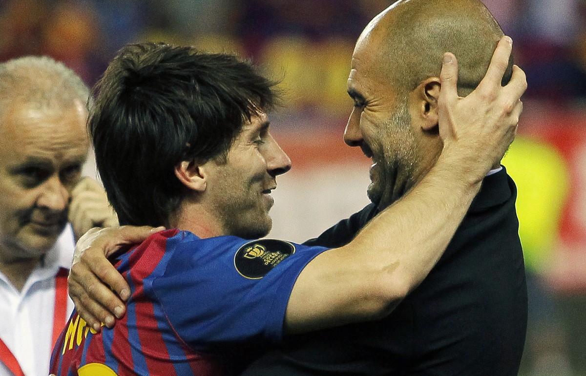 FC Barcelona's Lionel Messi from Argentina, left, celebrates his victory with coach Josep Guardiola during the final Copa del Rey soccer match against Athletic Bilbao at the Vicente Calderon stad ...