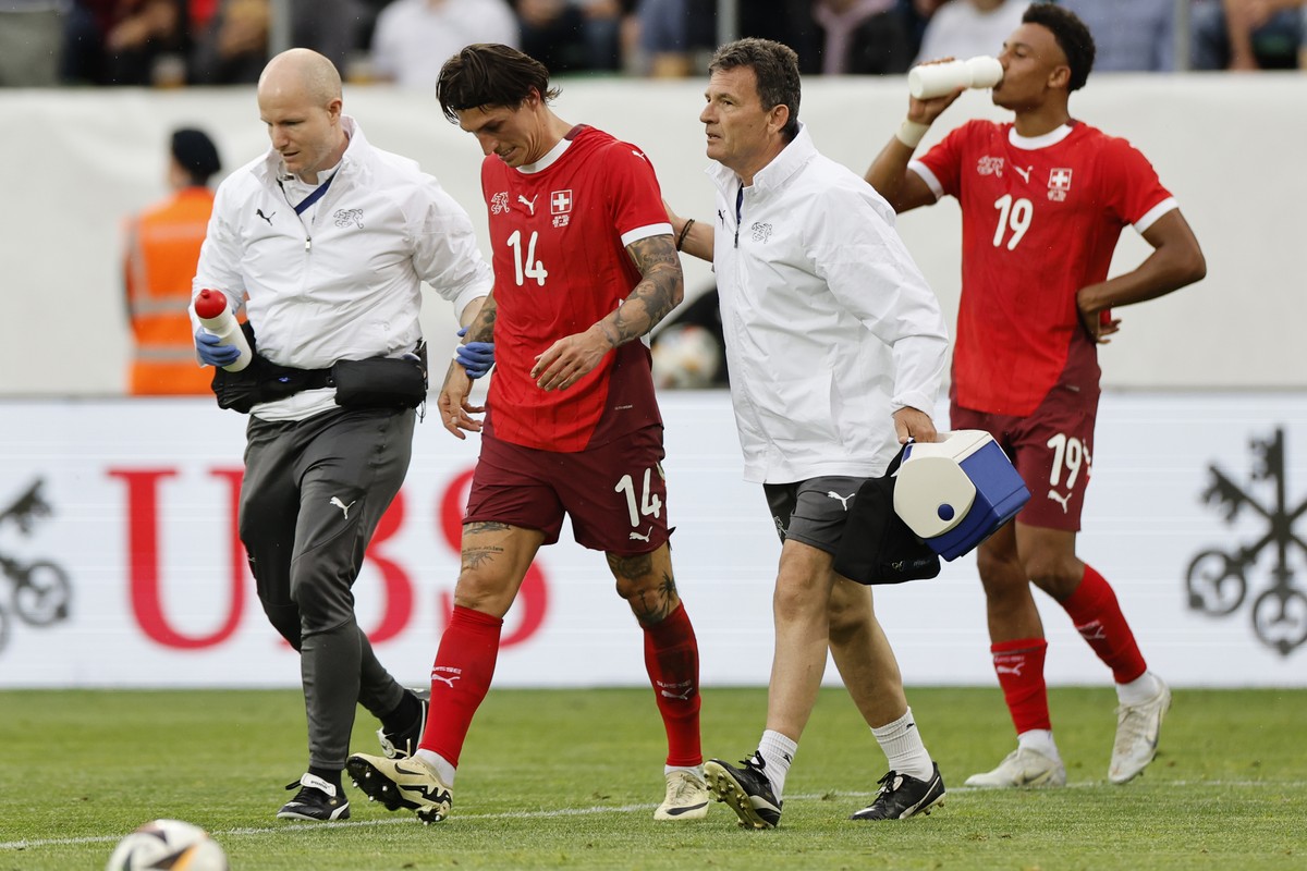 Switzerland's injured player Steven Zuber leaves the pitch during an international friendly soccer match between Switzerland and Austria at the kybunpark stadium in St. Gallen, Switzerland, Satur ...