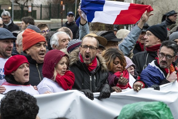 epa07325844 Laurent Soulie (C), at the initiative of the movement, takes part of a protest with thousands of &#039;Foulards Rouges&#039; (Red Scarfs) demonstrators march to support of the government p ...