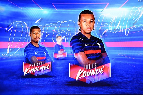 epa09209721 The portraits of France&#039;s defender Presnel Kimpembe and France&#039;s defender Jules Kounde are displayed as France&#039;s head coach Didier Deschamps (unseen) announces the France��� ...