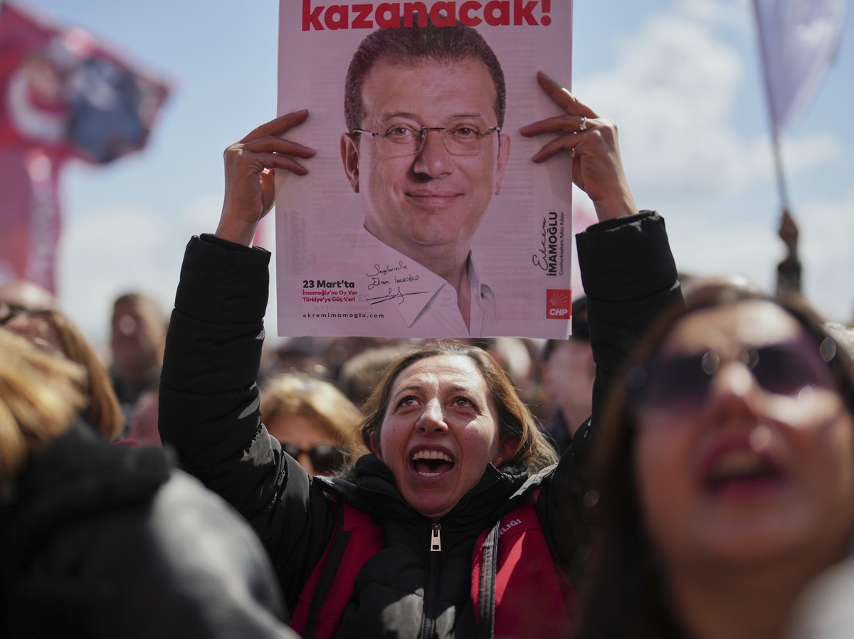 Supporters chant slogans while holding pictures of Istanbul Mayor Ekrem Imamoglu as they gather outside Silivri Prison, where a hearing is taking place for one of the multiple cases against him, west  ...