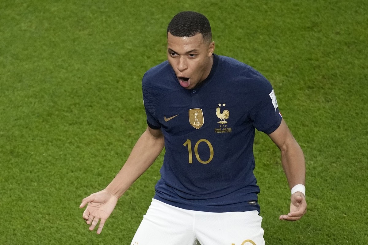 France's Kylian Mbappe celebrates after scoring his side's second goal during the World Cup round of 16 soccer match between France and Poland, at the Al Thumama Stadium in Doha, Qatar, Sund ...
