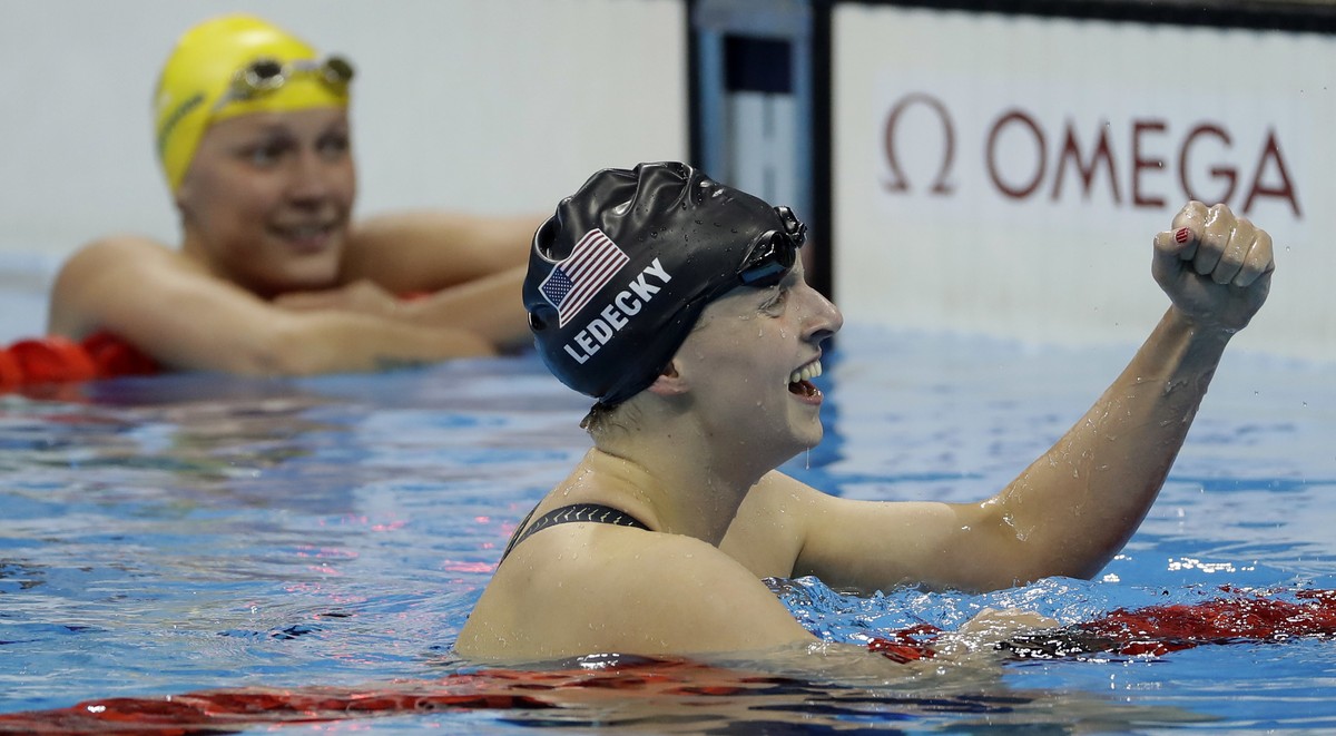 United States' Katie Ledecky celebrates winning the gold medal in the women's 200-meter freestyle ahead of second placed Sweden's Sarah Sjostrom, left, during the swimming competitions  ...