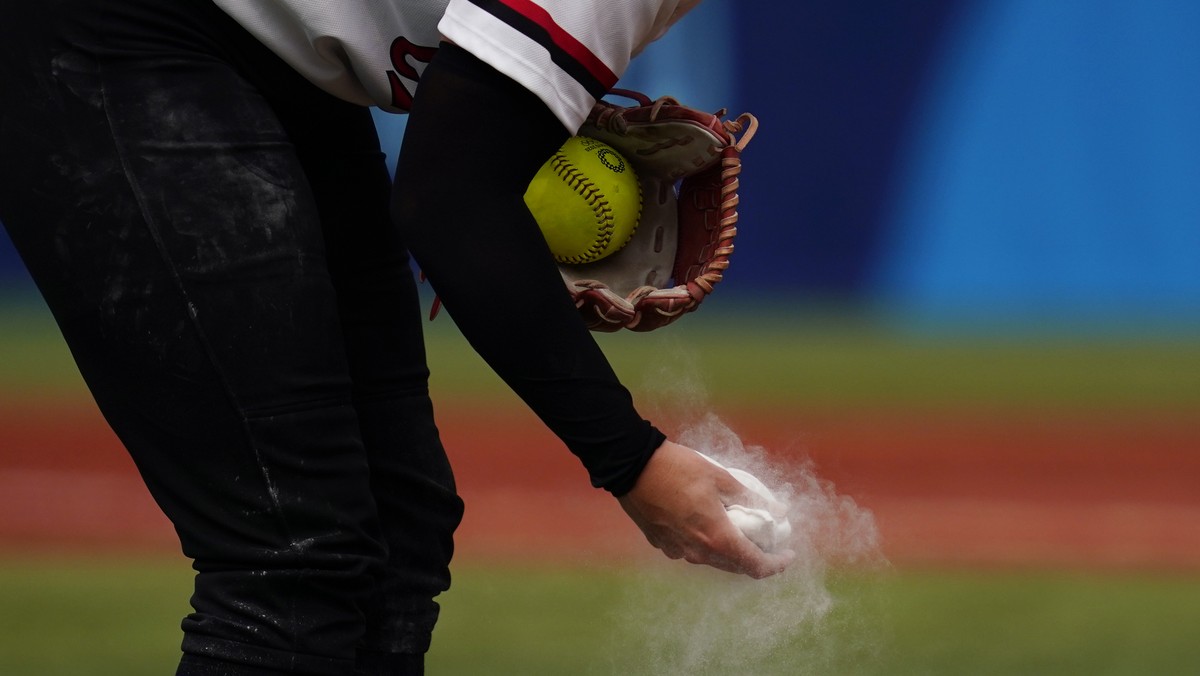 Canada's Danielle Lawrie squeezes a rosin bag while pitching during a softball game against Italy at Yokohama Baseball Stadium during the 2020 Summer Olympics, Monday, July 26, 2021, in Yokohama, ...