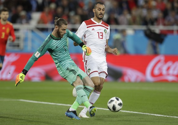 Spain goalkeeper David De Gea, kicks the ball next to Morocco&#039;s Khalid Boutaib during the group B match between Spain and Morocco at the 2018 soccer World Cup at the Kaliningrad Stadium in Kalini ...