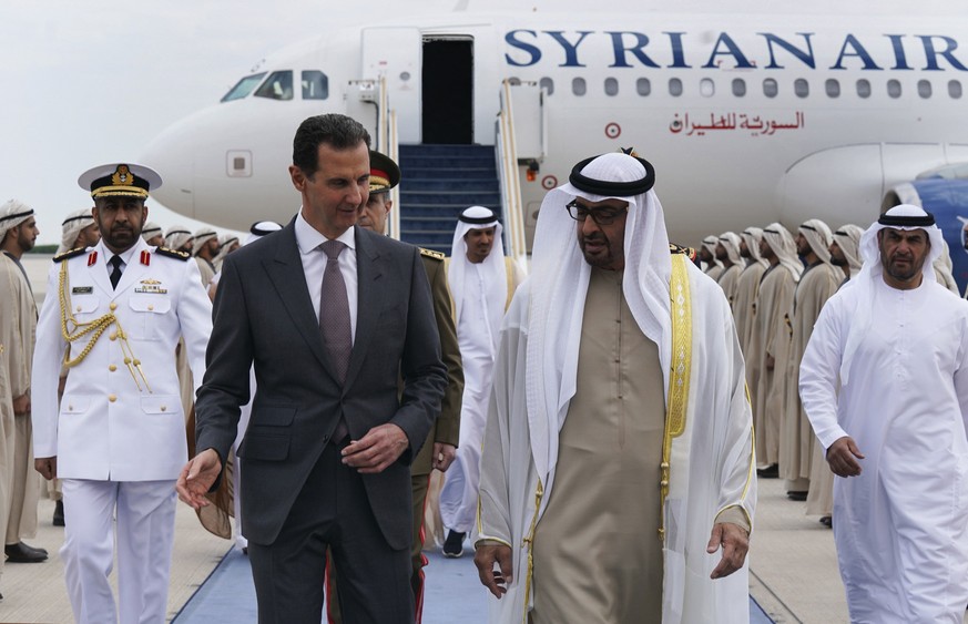 In this photo released by the Syrian Presidency, Syrian President Bashar Assad, left, speaks with UAE President Sheikh Mohammed bin Zayed Al-Nahyan, in in Abu Dhabi, United Arab Emirates, Sunday, Marc ...