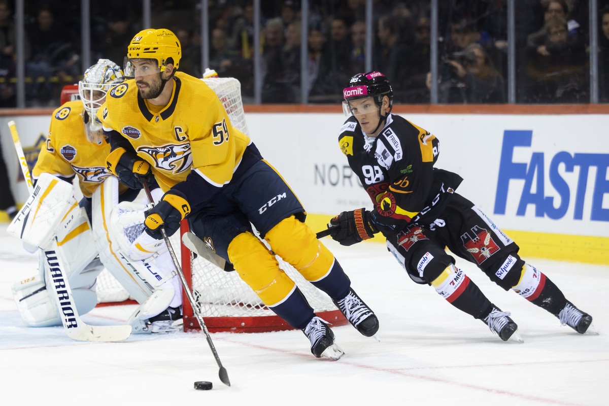 Nashville's Roman Josi, left, and Bern's Benjamin Baumgartner in action during the NHL Global Series Challenge ice hockey match between SC Bern and Nashville Predators in Bern, Switzerland,  ...