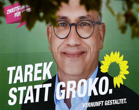 An election poster shows the top candidate of the Green Party for the Hesse state elections Tarek Al-Wazir in Frankfurt, Germany, Friday, Oct. 26, 2018. Hesse will have its elections on Sunday. The wr ...