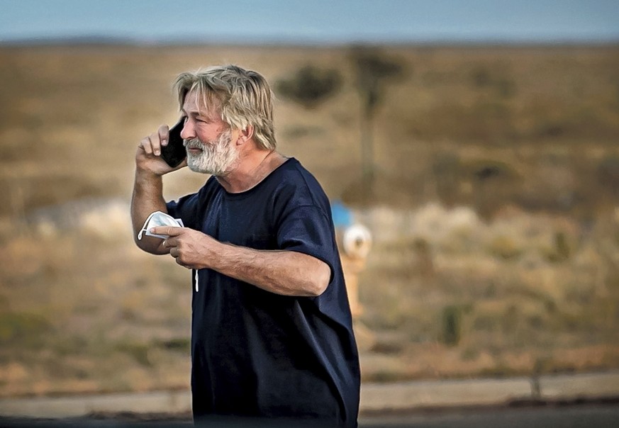 Alec Baldwin speaks on the phone in the parking lot outside the Santa Fe County Sheriff&#039;s Office in Santa Fe, N.M., after he was questioned about a shooting on the set of the film &quot;Rust&quot ...