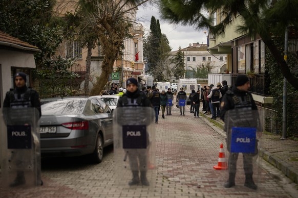 Turkish police officers stand guard in a cordoned off area outside Santa Maria church in Istanbul, Turkey, Sunday, Jan. 28, 2024. Two masked assailants attacked a church in Istanbul during Sunday serv ...