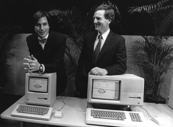 Apple-Mitbegründer Steve Jobs (l.) und der damalige Präsident John Sculley im Januar 1984 bei der Präsentation des ersten Macs.