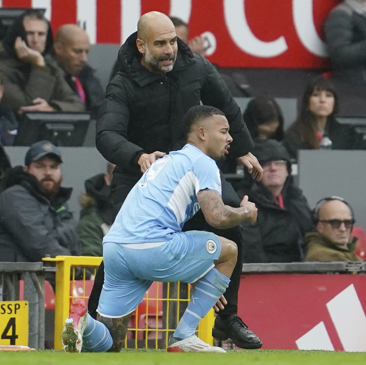 Manchester City's head coach Pep Guardiola, top, talks with his player Gabriel Jesus during the English Premier League soccer match between Manchester United and Manchester City at Old Trafford s ...