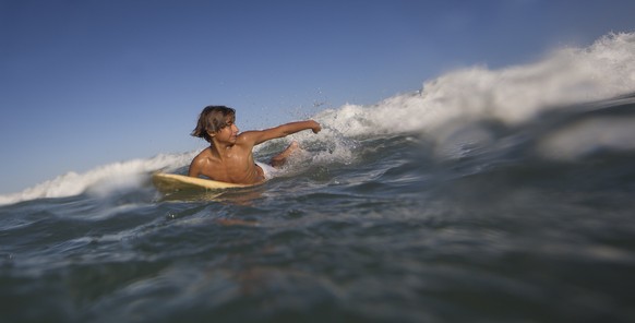 Eric Marques paddles to catch a wave during his surfing class off Sao Conrado beach in Rio de Janeiro, Brazil, Saturday, Aug. 13, 2016. “I love surfing. I love being in the water. There’s not much for ...