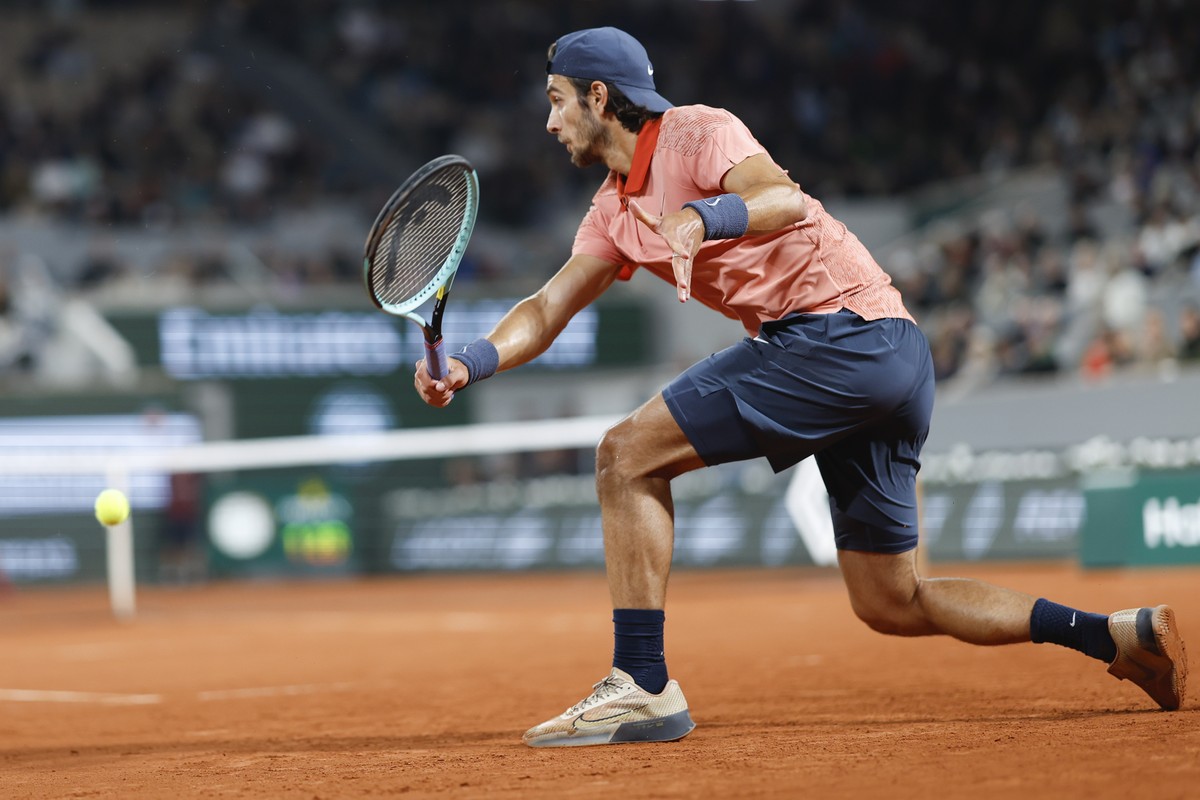Italy's Lorenzo Musetti plays a shot against Serbia's Novak Djokovic during their third round match of the French Open tennis tournament at the Roland Garros stadium in Paris, Sunday, June 2 ...
