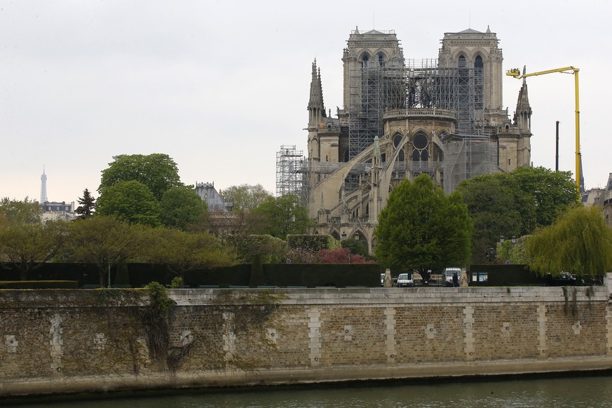 The Eiffel Tower, left, and Notre Dame cathedral are picturd Tuesday April 16, 2019 in Paris. Firefighters declared success Tuesday in a more than 12-hour battle to extinguish an inferno engulfing Par ...