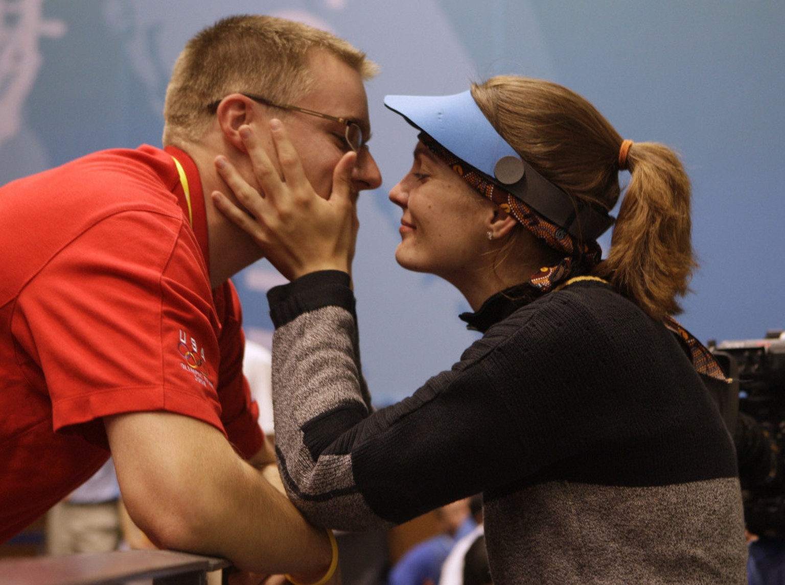 Czech Republic's Katerina Emmons is congratulated by her husband Matt Emmons of the US after winning the first gold medal of the games in the Women's 10 meters air rifle final round at the Shooting Ra ...