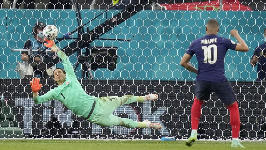 Switzerland&#039;s goalkeeper Yann Sommer saves the penalty shot by France&#039;s Kylian Mbappe during the Euro 2020 soccer championship round of 16 match between France and Switzerland at the Nationa ...