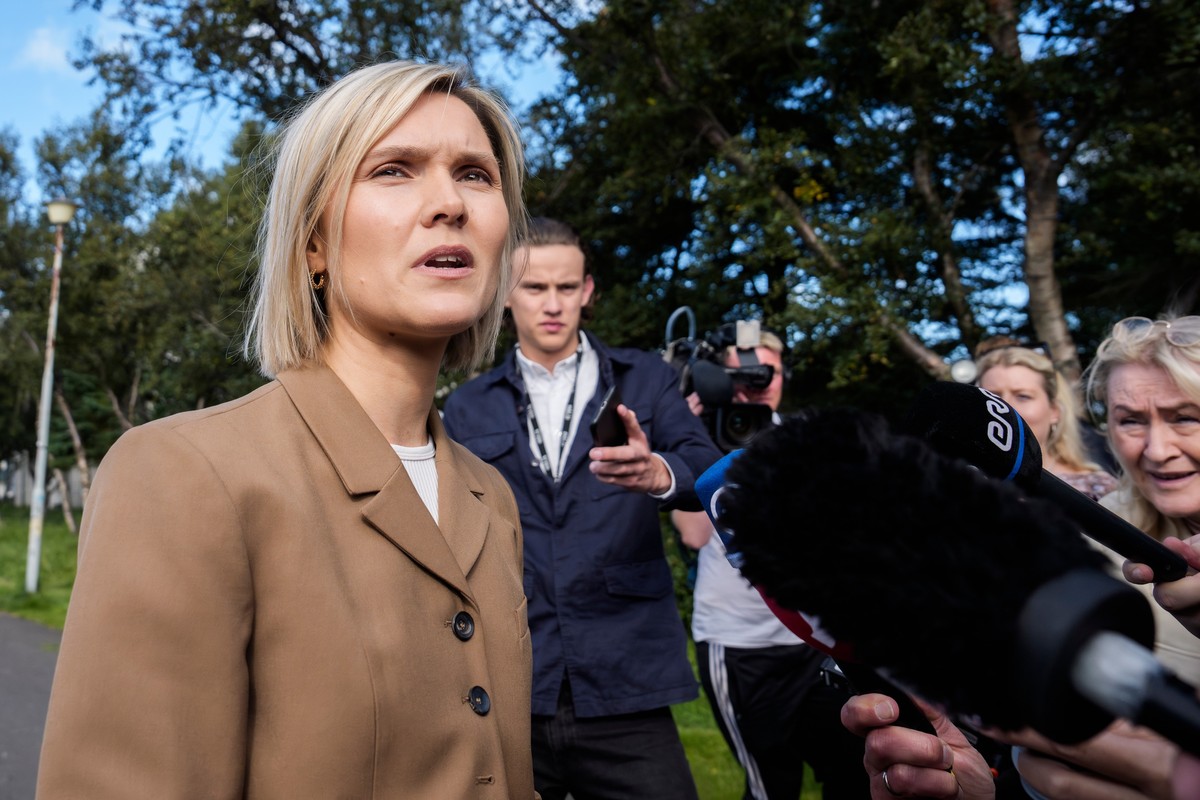 Icelandic Prime Minister Kristrún Frostadóttir, left, speaks to reporters after casting her ballot at Álftamýrarskóli polling station in Reykjavik, Iceland, Saturday, Aug. 29, 2026. (AP Photo/Marco Di ...