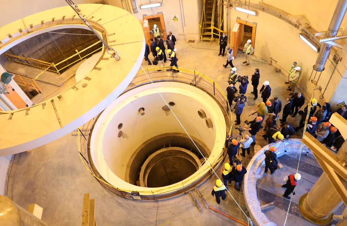 epa08088084 A handout photo made available by Iran's Atomic Energy Organisation shows head of the organisation Ali Akbar Salehi (C) speaks to media during his visits to nuclear water reactor of A ...