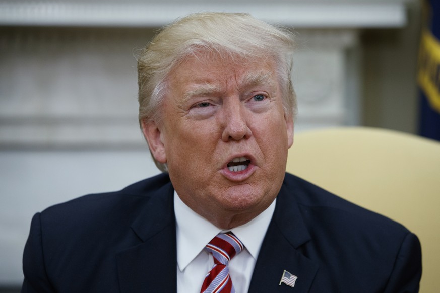 President Donald Trump talks to reporters during a meeting with Dr. Henry Kissinger, former Secretary of State and National Security Advisor under President Richard Nixon, in the Oval Office of the Wh ...