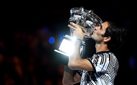 epa05759044 Roger Federer of Switzerland celebrates with the trophy after winning the Men&#039;s Singles final match against Rafael Nadal of Spain at the Australian Open Grand Slam tennis tournament i ...
