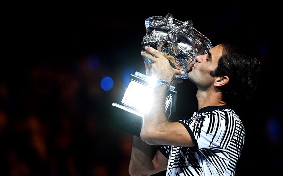 epa05759044 Roger Federer of Switzerland celebrates with the trophy after winning the Men's Singles final match against Rafael Nadal of Spain at the Australian Open Grand Slam tennis tournament i ...