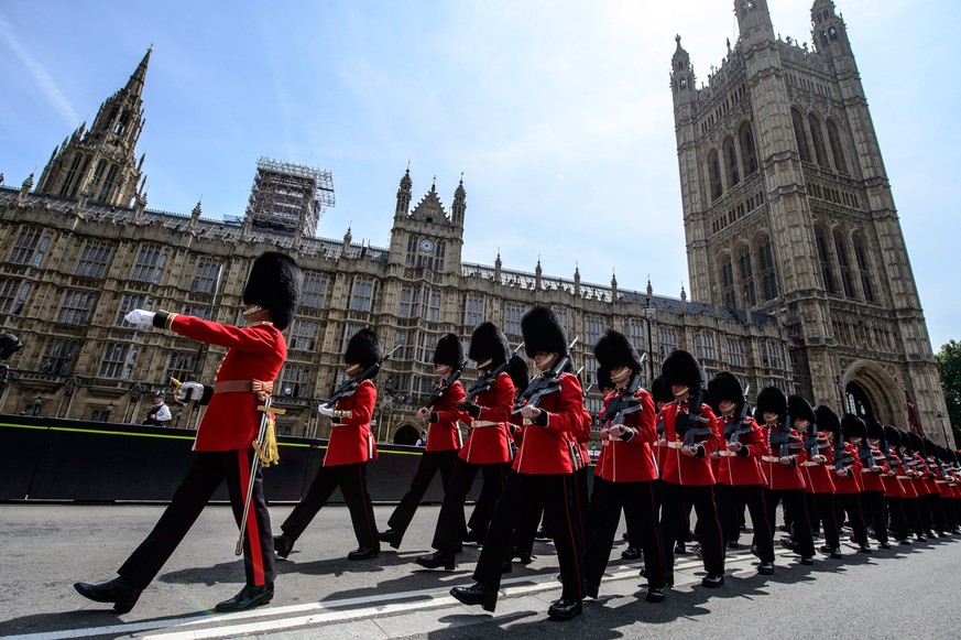 epa06041067 A handout image made available by the British Ministry of Defence (MOD) shows 1st Battalion Coldstream Guards provided a Guard of Honour of 96 Rank and File, with The State Colour prior th ...