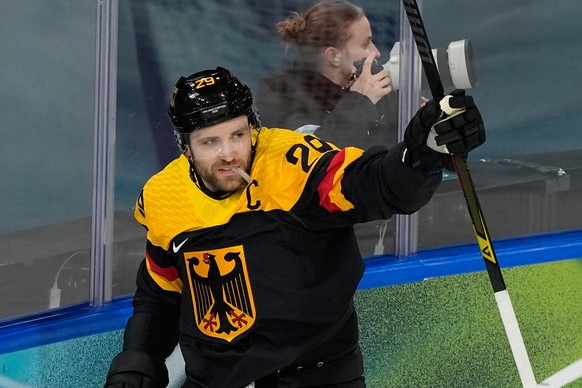 Germany's Leon Draisaitl (29) celebrates after scoring her side's opening goal during a preliminary round match of men's ice hockey between Germany and Denmark at the 2026 Winter Olympi ...