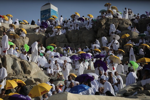epa10058950 Muslim Hajj pilgrims climb Gebel Rahmah (Mount of Mercy) where the Prophet Mohamed gave his last sermon, as people congregate on the plains of Arafat, southeast of Mecca, Saudi Arabia, 08  ...