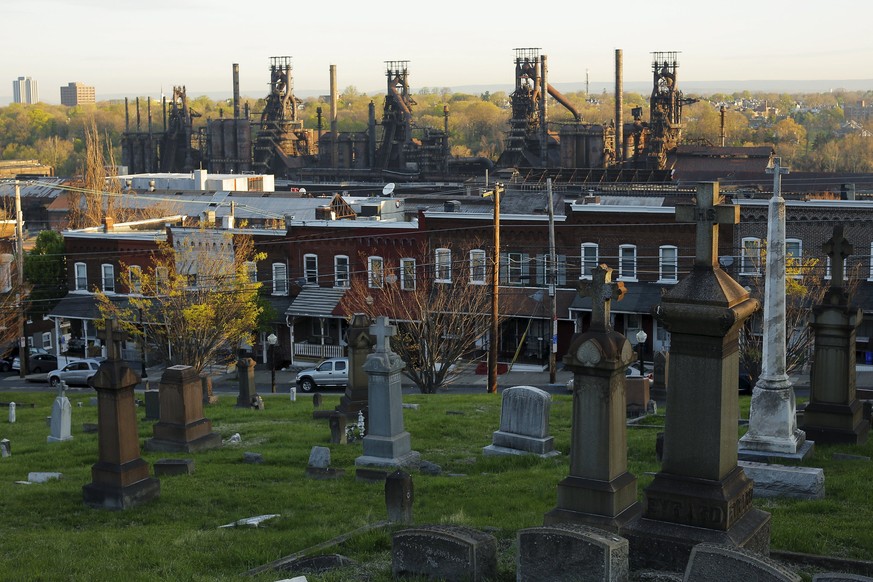 The blast furnaces of the now-closed Bethlehem Steel mill, sit behind row houses and a cemetery in Bethlehem, Pennsylvania, U.S. April 21, 2016. After Bethlehem Steel&#039;s blast furnaces went silent ...