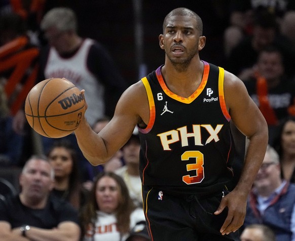 FILE - Phoenix Suns guard Chris Paul moves the ball down the court against the Los Angeles Clippers during the second half of Game 5 of a first-round NBA playoff series on April 25, 2023, in Phoenix.  ...