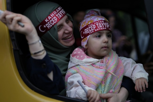 A supporter of the President Recep Tayyip Erdogan celebrates outside AK Party offices in Istanbul, Turkey, Sunday, May 28, 2023. Erdogan takes lead in unofficial count in Turkey&#039;s presidential ru ...