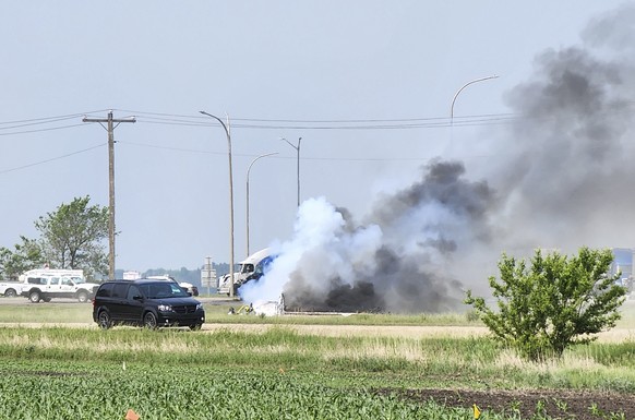 epa10693972 A vehicle on fire at the scene of a deadly accident involving a semi-trailer truck and a small bus where at least 15 people have reportedly been killed in the town of Carberry, located in  ...