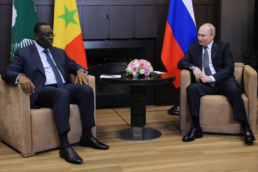 Russian President Vladimir Putin, right, speaks to Senegalese President and the chairman of the African Union Macky Sall during their meeting in the Bocharov Ruchei residence in the Black Sea resort o ...