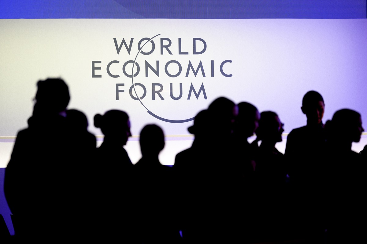 epa11838084 Participants walk under a WEF logo inside the congress center prior to the 55th annual meeting of the World Economic Forum (WEF) in Davos, Switzerland, 20 January 2025. The World Economic  ...