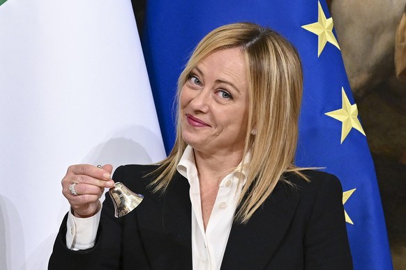 epa10260562 Italy&#039;s Prime Minister Giorgia Meloni poses with the bell used by the cabinet president to manage cabinet debates, during the handover ceremony at Chigi Palace in Rome, Italy, 23 Octo ...