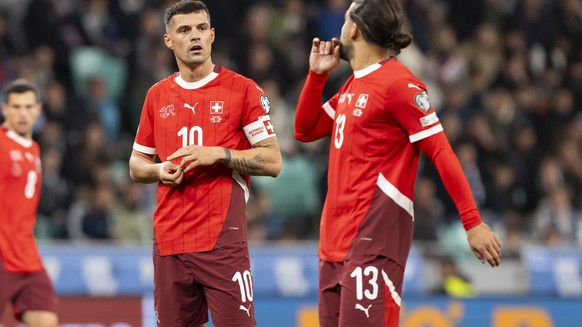 Switzerland's Granit Xhaka, left, talks to Switzerland's Ricardo Rodriguez, right, during the FIFA World Cup 26 UEFA Qualifiers Group B match between Slovenia and Switzerland, at Stozice Sta ...