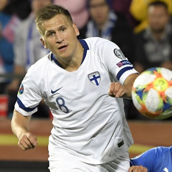 Finland&#039;s Robin Lod, left, and Teemu Pukki battle for the ball with Armando Izzoi of Italy during the Euro 2020 Group J qualifying soccer match between Finland and Italy in Tampere, Finland, Sund ...