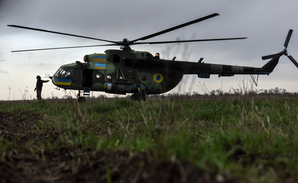 epa10564651 A Ukrainian pilot stands next to an MI-8 helicopter at an undisclosed location in eastern Ukraine, 08 April 2023. Russian troops entered Ukrainian territory on 24 February 2022, starting a ...