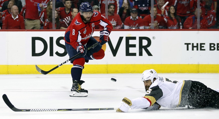 Washington Capitals forward Alex Ovechkin, left, of Russia, flips the puck over Vegas Golden Knights defenseman Deryk Engelland during the second period in Game 4 of the NHL hockey Stanley Cup Final,  ...