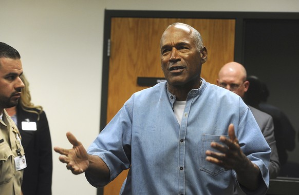 FILE - Former NFL football star O.J. Simpson reacts after learning he was granted parole at the Lovelock Correctional Center in Lovelock, Nev., on July 20, 2017. The 74-year-old former football hero,  ...