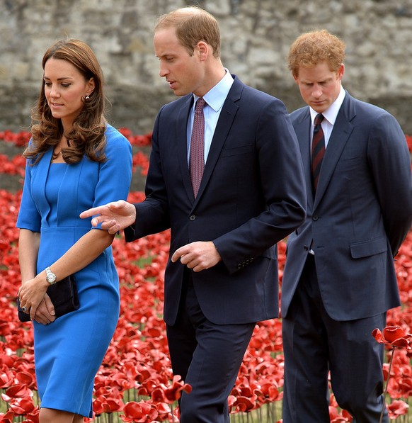 From left, Kate, the Duchess of Cambridge, her husband Britain's Prince William, the Duke of Cambridge, and his brother Prince Harry visit Paul Cummins' art installation entitled 'Blood Swept Lands and Seas of Red' for its official unveiling in the dry moat of the Tower of London in London, Tuesday, Aug. 5, 2014. Their visit to the work in progress installation, which currently consists of approximately 120,000 ceramic poppies and will finish with 888,246 poppies, was held Tuesday to mark the centenary of World War I. The final ceramic poppy will be placed on Armistice Day on November 11, with each poppy representing a British and Commonwealth military fatality from World War I. (AP Photo/John Stillwell, Pool)